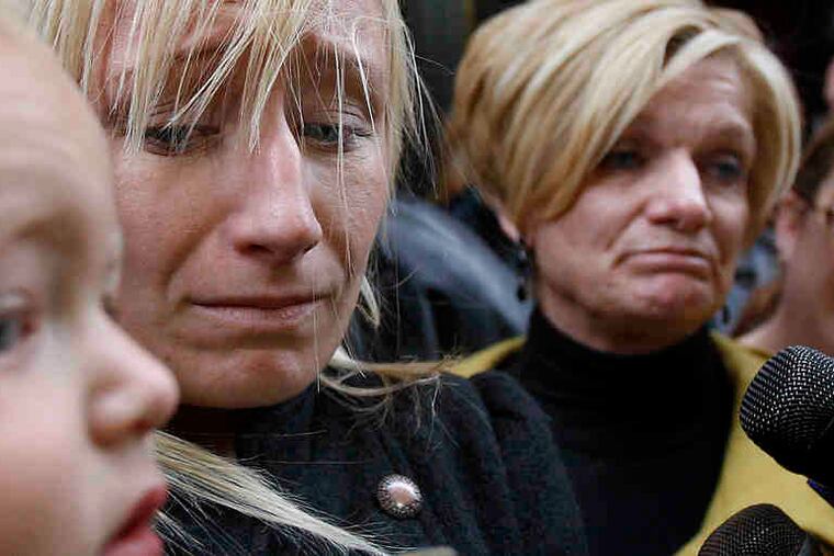 "I'm angry and I'm frustrated," said Officer John Pawlowski's widow, Kim (second from left), holding son John III.