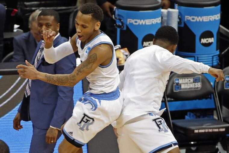 Rhode Island’s Fatts Russell (left) celebrates with a teammate after the Rams’ 83-78 overtime win against Oklahoma in an NCAA tournament first round game in Pittsburgh.