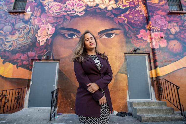 Siria Rivera, the new director of the Providence Center in Fairhill, stands in front of a mural outside her office. The Five-Year American Community Survey shows that Fairhill continues to be the poorest neighborhood in the city