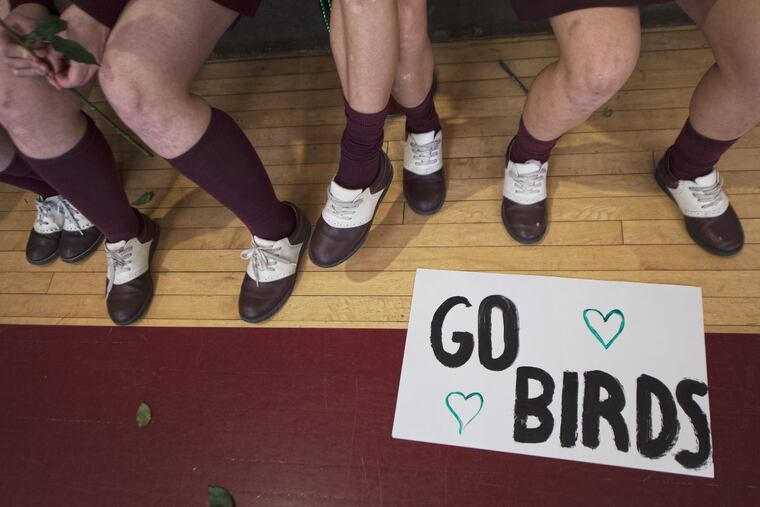 A “Go Birds” sign is shown near the feet of freshmen during a pep rally with teachers and students at the Little Flower Catholic High School for Girls in Philadelphia.