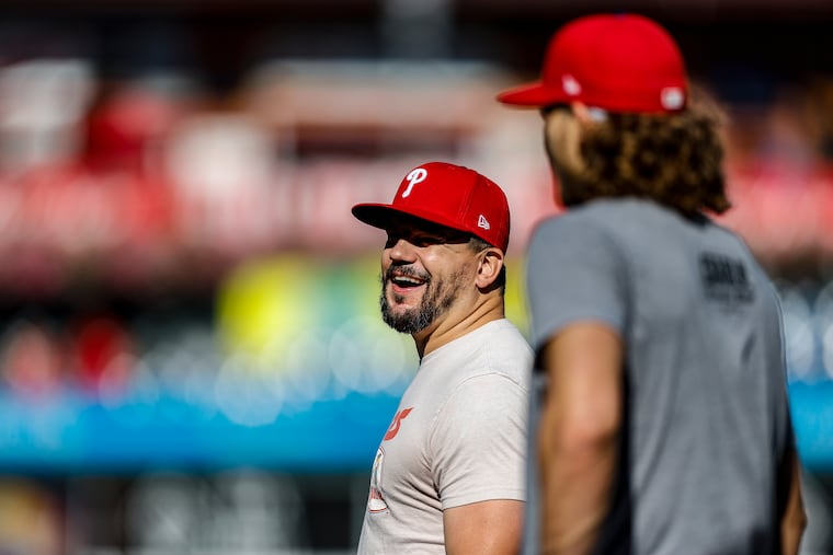 Kyle Schwarber and Alec Bohm during chat during batting practice ahead of Game 6 of the NLCS against the Arizona Diamondbacks at Citizens Bank Park.