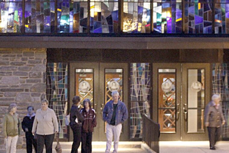 Parishioners leave after gathering Tuesday to discuss how to get priest Msgr. Michael Flood reinstated at St. Luke the Evangelist Church in Glenside. (Elizabeth Robertson / Staff Photographer)