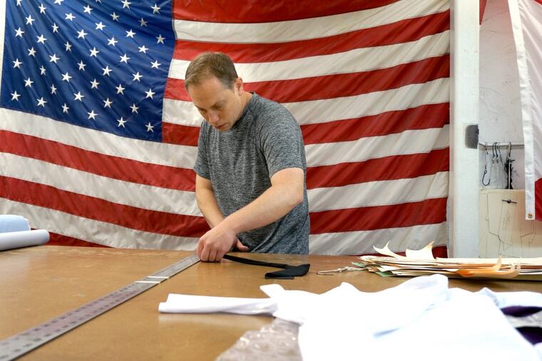 In ATK’s Kensington factory, founder/president Scott Savett measures fabric for his short athletic shorts