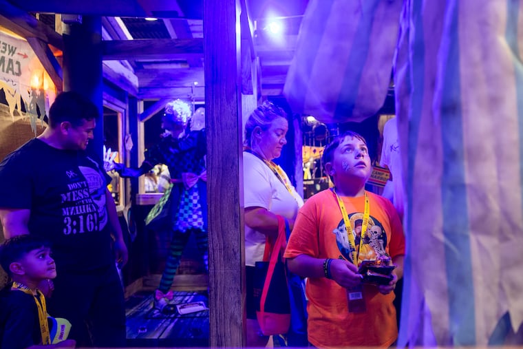 Lucas O’Donnell, 10, of Levittown, is looking at the Crackles animatronic at the Spirit Halloween flagship store in Egg Harbor Township, N.J., at the Saturday grand opening.
