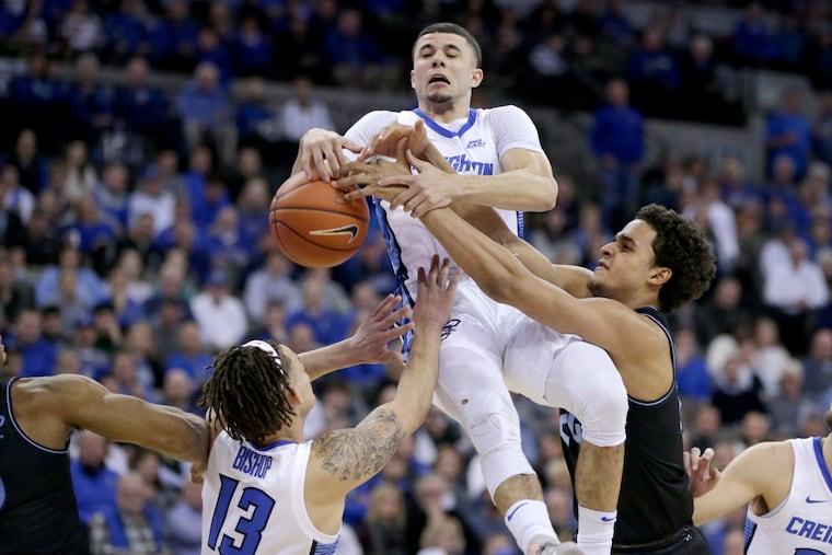 Creighton's Christian Bishop (13) and Marcus Zegarowski and Villanova's Jeremiah Robinson-Earl go for a rebound during the first half.