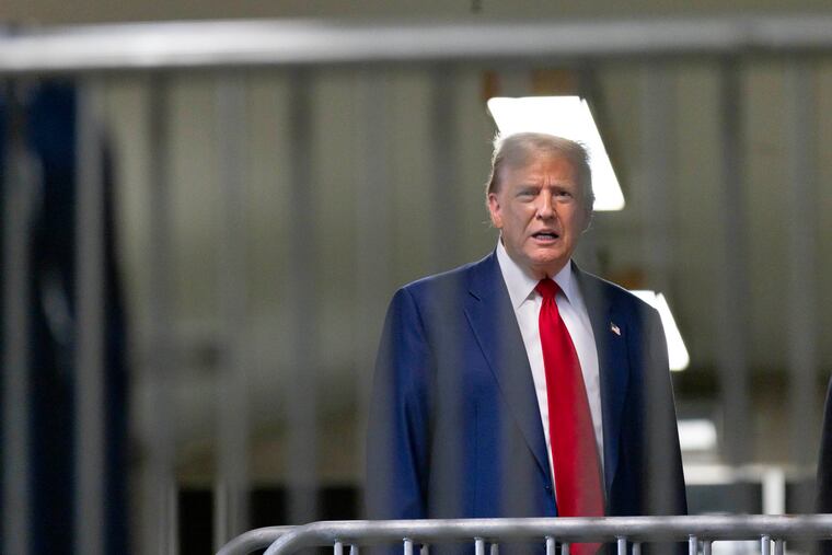 Former President Donald Trump talks to reporters as leaves the courtroom following the day's proceedings in his trial at Manhattan criminal court in New York on Tuesday.