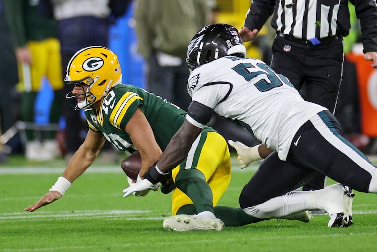 Eagles edge rusher Jalyx Hunt sacks Packers quarterback Jordan Love in the first quarter at Lambeau Field.