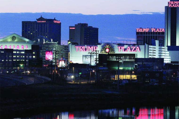 The parent company of Caesar's (left), Caesars Entertainment Corp., is contending with more than $20 billion in debt. (Mel Evans / Associated Press)