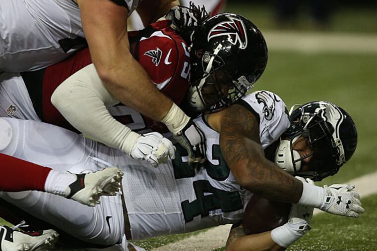 Ryan Matthews is tackled by a Falcons defender.