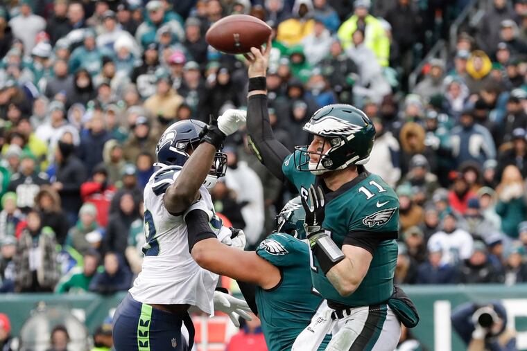 Carson Wentz throwing a pass in the Eagles' Week 12 loss to the Seahawks. Wentz turned the ball over four times in that game. He'll get an opportunity to redeem himself in Sunday's wild-card rematch.