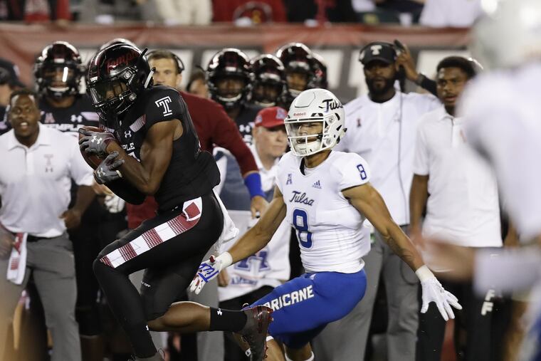 Temple cornerback Ty Mason intercepts the football in front of Tulsa wide receiver Keenen Johnson during the first-quarter on Thursday, September 20, 2018 in Philadelphia. Mason scored a 36-yard touchdown after the interception. YONG KIM / Staff Photographer