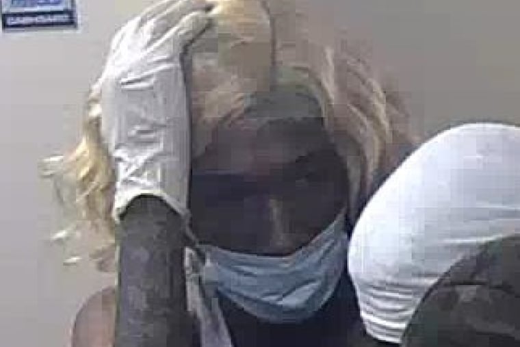 A still from surveillance footage shows a man, who FBI agents have identified as Raphael Shaw, inside a Wells Fargo branch in the ParkWest Town Center on May 31, moments before he allegedly returned with accomplices and a forklift to steal the cash vault.