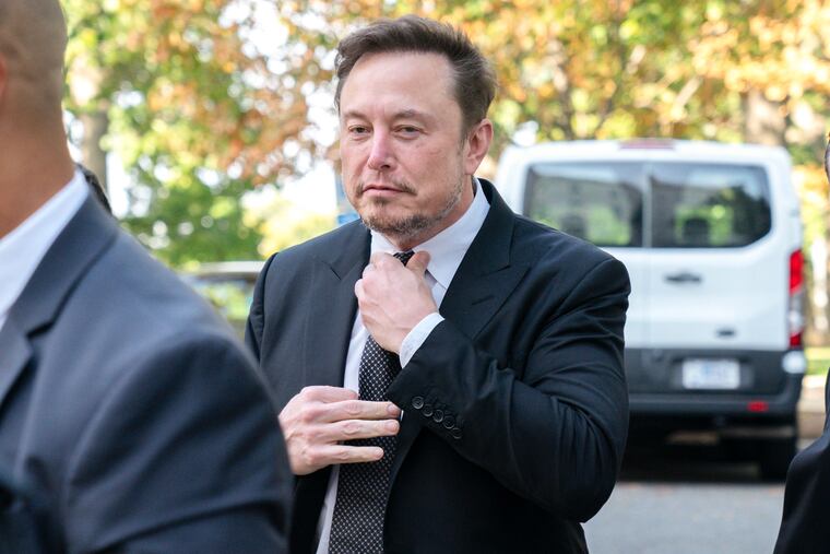 Elon Musk, CEO of X, the company formerly known as Twitter, tightens his tie as he arrives for a closed-door gathering of leading tech CEOs to discuss the priorities and risks surrounding artificial intelligence and how it should be regulated, at Capitol Hill in Washington, in September.