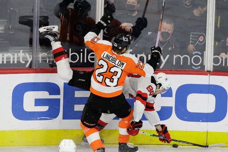 Flyers left winger Oskar Lindblom checks New Jersey Devils defenseman Kevin Bahl in the teams' season finale on May 10.