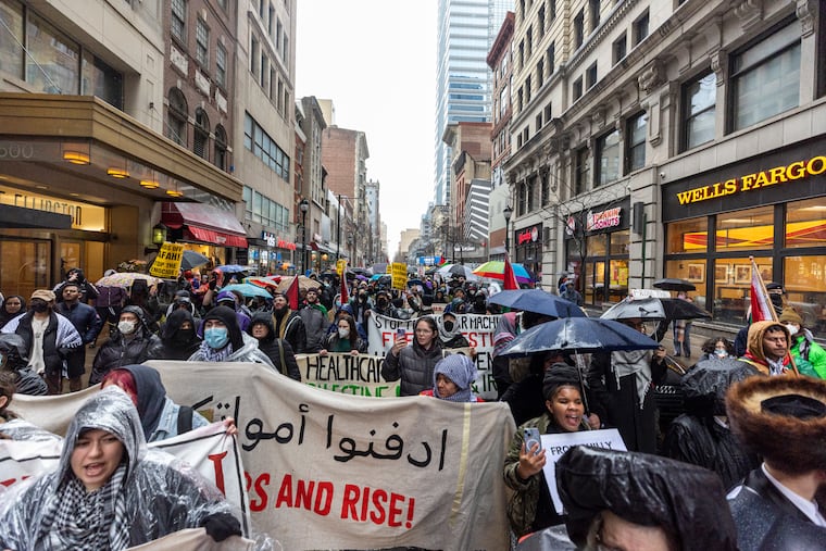 People fill the streets along Chestnut Street during the march with the All Out for Gaza protest on a rainy Saturday.