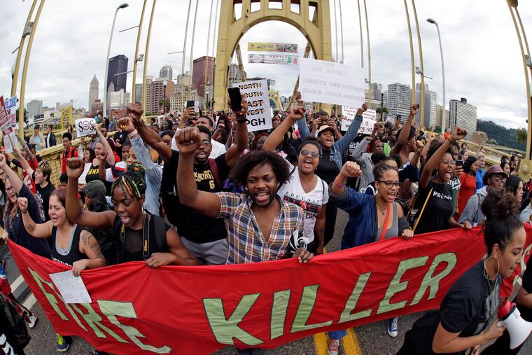 Protestors cross the Roberto Clemente bridge during a evening rush hour march that began in downtown Pittsburgh Friday, June 22, 2018. They are protesting the killing of Antwon Rose Jr. who was fatally shot by a police officer seconds after he fled a traffic stop late Tuesday, in the suburb of East Pittsburgh.