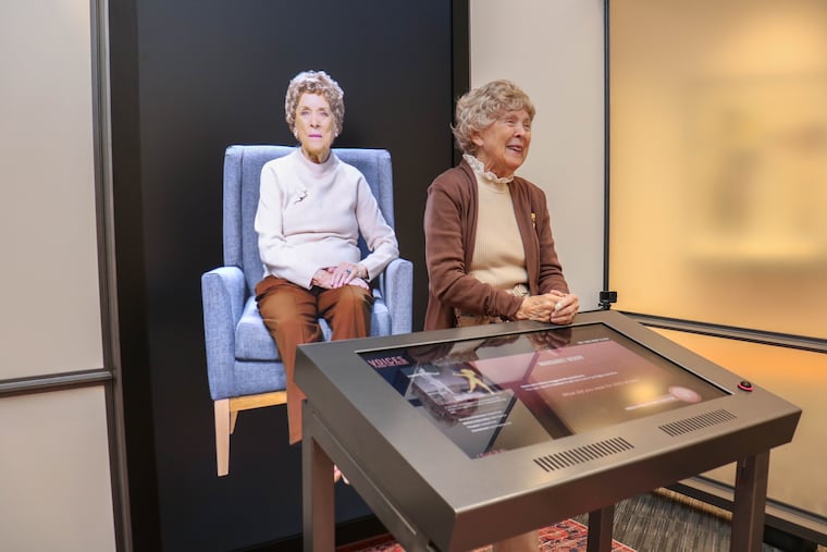 Margaret Kerry-Boeke, who was a USO dancer as well as the inspiration for Disney's Tinker Bell, stands with her video image at the Voices From the Front exhibit at the National WWII Museum in New Orleans in 2024.