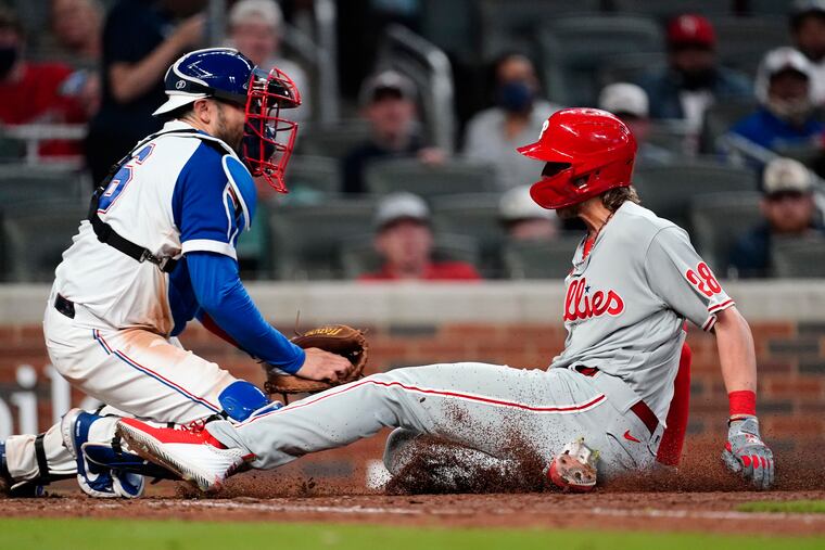 Alec Bohm slides into home plate with the go-ahead run in the ninth inning of the Phillies' 7-6 victory over the Braves on Sunday night in Atlanta.