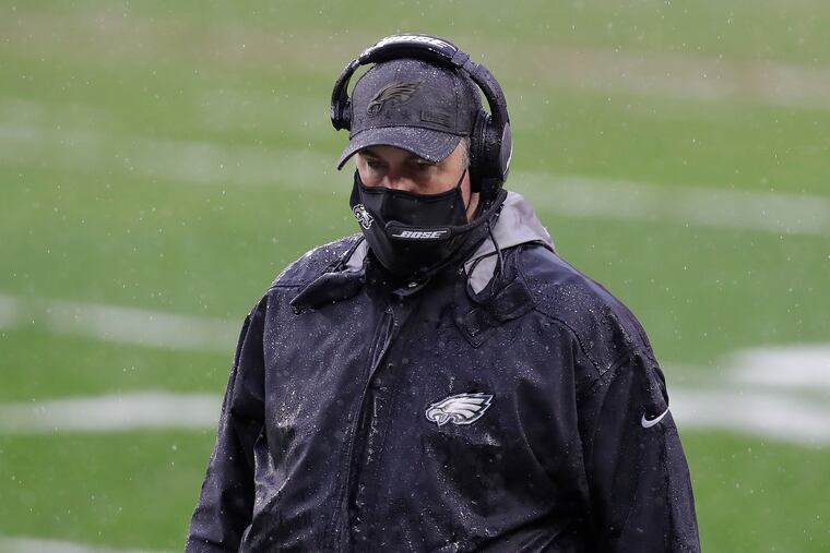 Eagles coach Doug Pederson on the rain-soaked sideline in Cleveland looks down during the third quarter against the Cleveland Browns on Sunday, November 22, 2020.