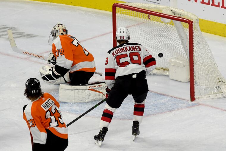 Flyers goalie Carter Hart lets a shot from New Jersey's Kyle Palmieri (not shown) get past him for a goal in the first period Tuesday.