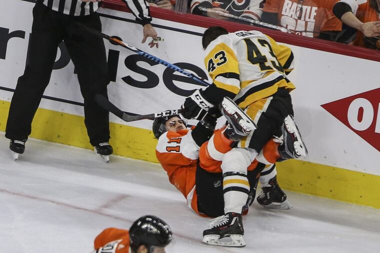 Flyers’ Travis Konecny gets tangled with Penguins’ Conor Sheary during the Flyers’ loss on Sunday.
