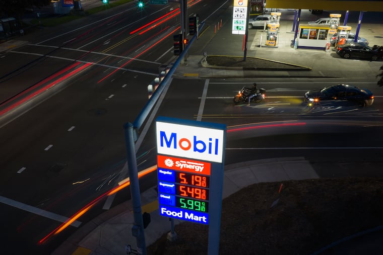 In this photo taken with a slow shutter speed, traffic moves past a sign for a Mobil gas station on Wednesday, April 29, 2026, in Portland, Ore.