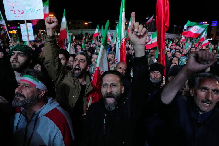 Iranian pro-government demonstrators chant slogans in a gathering in Tehran's Revolution Square on Wednesday after the United States and Iran agreed to a two-week ceasefire.