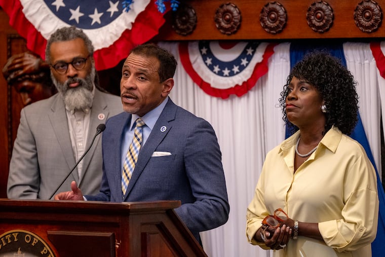 Mayor Cherelle L. Parker looks on as Superintendent Tony B. Watlington Sr. speaks at City Hall on Thursday, after City Council rejected most of her tax proposals for the city budget. School Board President Reginald L. Streater is at left.