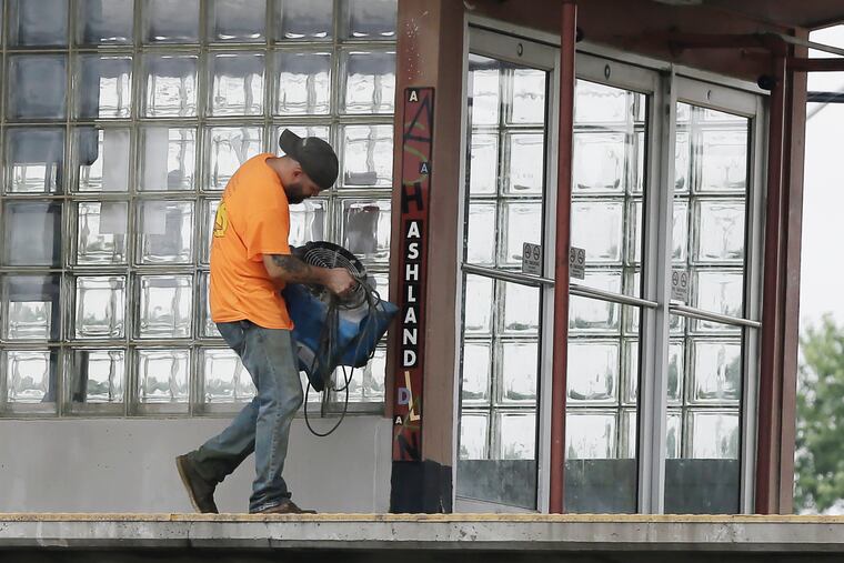 A worker at PATCO’s Ashland Station on Burnt Mill Road in Voorhees carries a fan from the platform to an area downstairs. Flooding from overnight thunderstorms kept the station closed to riders on June 20, 2019.