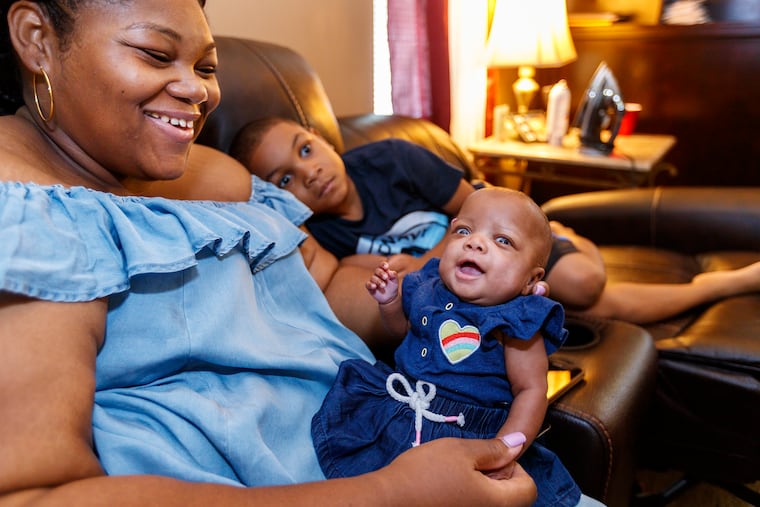 MaKenna Spruill, right, 5 months old, smiles a big smile as her mother, Alyssa Spruill, left, talks to her.