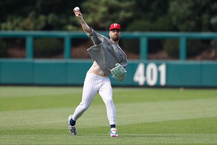 Bryce Harper, warming up before the Phillies play Nationals on Monday, will move back to right field.