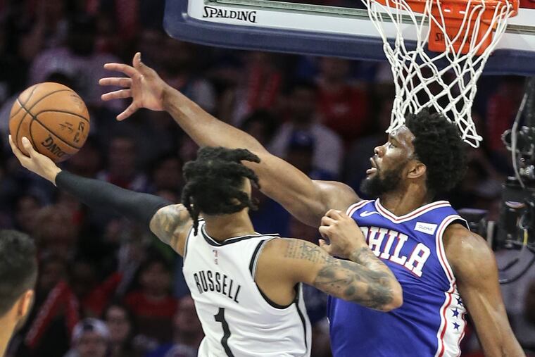 Sixers' Joel Embiid tries to block Nets' D'Angelo Russell during the 3rd quarter of Game 5 of the first round of the NBA playoffs at the Wells Fargo Center in Philadelphia, Tuesday, April 23, 2019. Sixers beat the Nets 122-100 to win the first round of the playoffs (4-1).