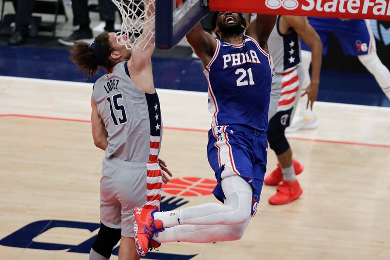 Sixers center Joel Embiid drives to the basket against Washington Wizards center Robin Lopez during the first quarter.