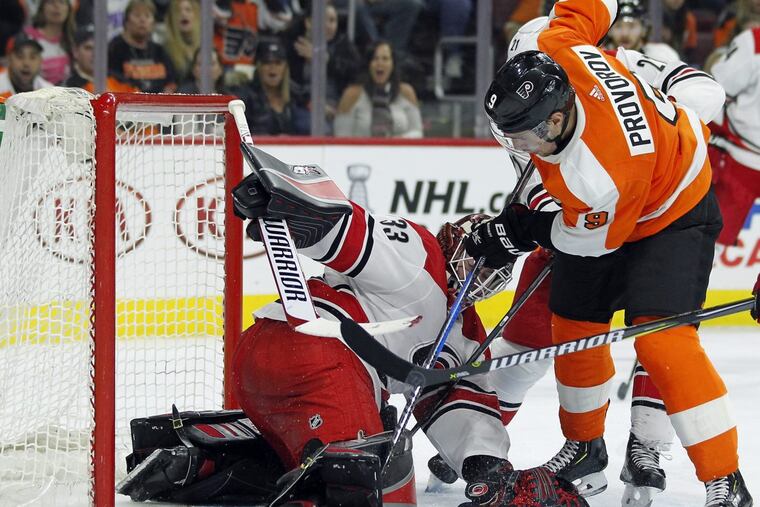 Flyers defenseman Ivan Provorov knocks the puck past past Carolina goaltender Scott Darling to tie the score at 2-2 late in the second period Thursday.