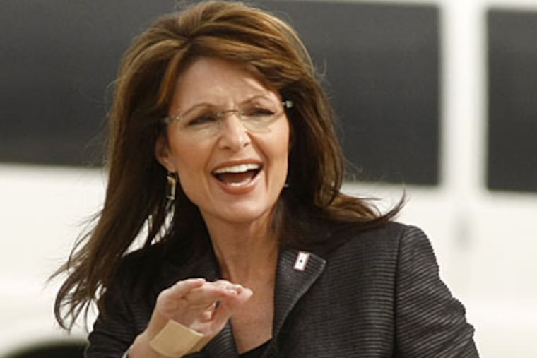 Republican vice presidential running mate, Alaska Gov. Sarah Palin, waves as she walks across the tarmac to meet Republican presidential candidate, Sen. John McCain, R-Ariz., after arriving for a rally today in Allentown. (AP Photo/Gerald Herbert)