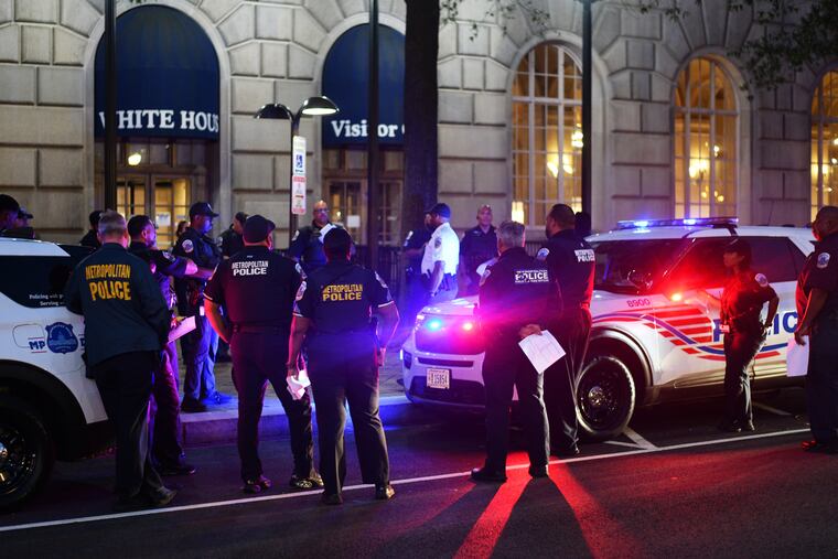 D.C. police officers gather on Pennsylvania Avenue near the White House on Aug. 23.