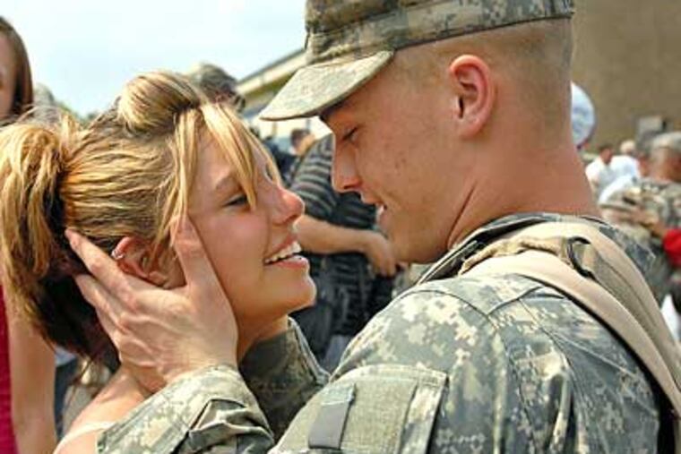 Elizabeth Fahy of Blackwood and her boyfriend Elwood Humphries are reunited at Ft. Dix after he and members of New Jersey's 50th Infantry Brigade Combat Team returned from Iraq. (Tom Gralish / Staff Photographer)