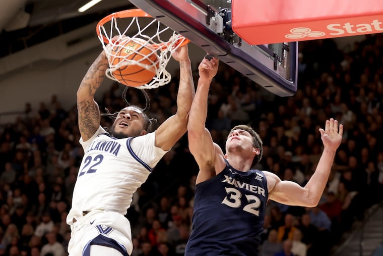 Cam Whitmore (left) of Villanova dunks over Zach Freemantle of Xavier during the 1st half of their game on Jan. 7, 2023 at the Finneran Pavilion at Villanova University.