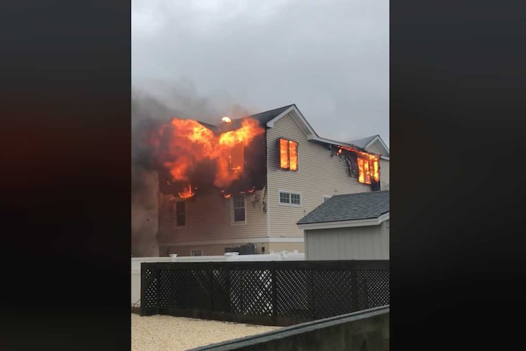 Video shows flames engulfing the top floor of a Long Beach Island house after it was struck by lightning during the nor'easter.