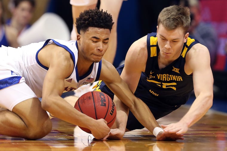 Kansas' Devon Dotson (left) leads the Big 12 in scoring.