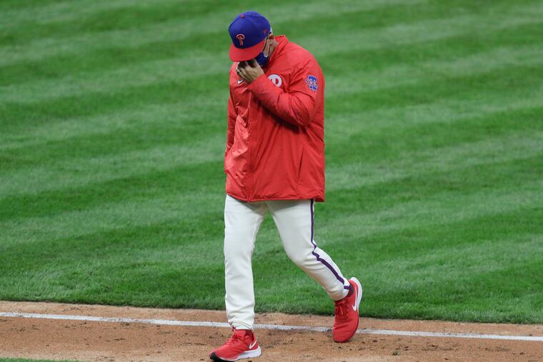 Joe Girardi walking back to the Phillies dugout after making a pitching change.