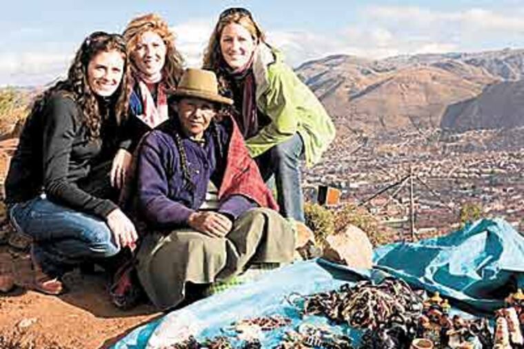 The Foley sisters - (from left) Erin, Shannon and Molly - in Peru with a merchant they met. (Gary Noel)