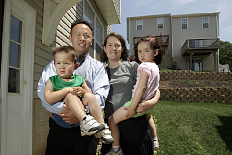 Victor Ko, wife Eileen and their children, Andrew, 3, and Elisabeth, 4, at their Drexel Hill home. Victor pays about $7,000 in taxes for his home valued at about $250,000. (Laurence Kesterson / inquirer)