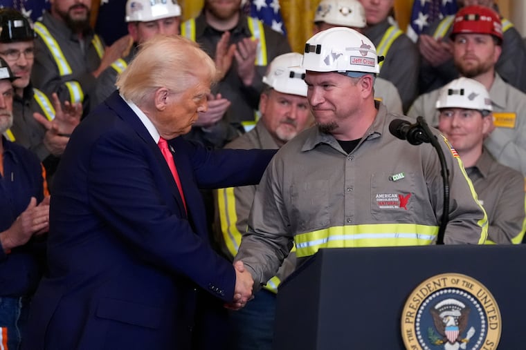 President Donald Trump shakes hands with coal miner Jeff Crowe during an event on energy production in the East Room of the White House, Tuesday in Washington.