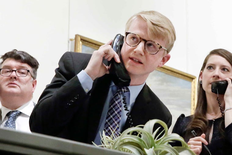 Freeman's auction house employees bid for clients during the auction of items from an estate in April 2018. Freeman's is merging with Chicago-based Hindman in a deal that will expand the Philadelphia company’s national profile.