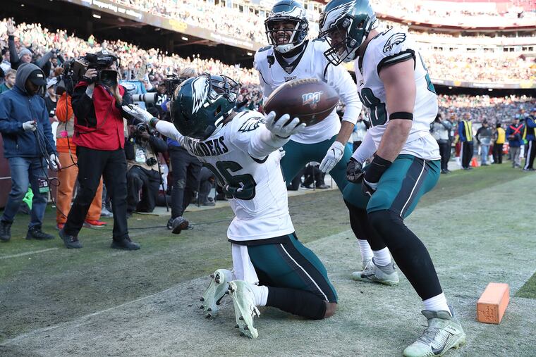 Eagles running back Miles Sanders celebrates a touchdown with wide receiver J.J. Arcega-Whiteside (center) and tight end Dallas Goedert.