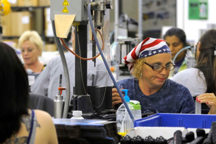Betty Jo Durham working in red, white, and blue on the assembly line at Princeton Tectonic in Bordentown. She is not sure whom she will vote for next month. TOM GRALISH / Staff Photographer