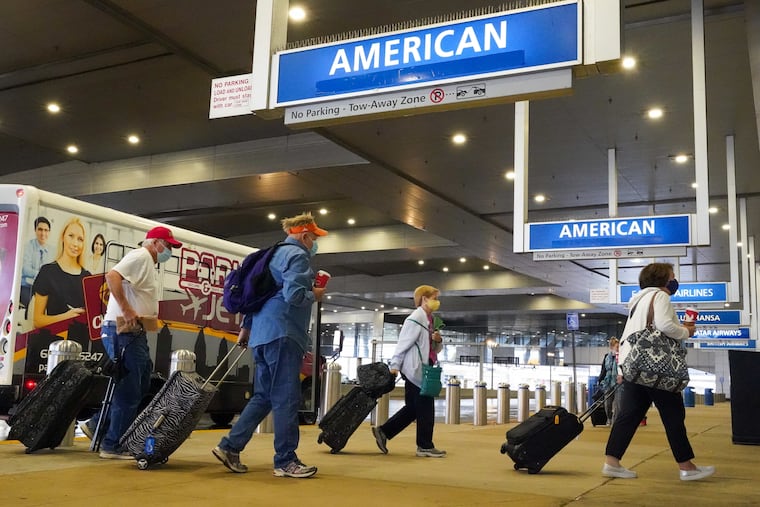 Passengers arrive at American Airlines in Philadelphia International Airport on Nov. 12, 2021.