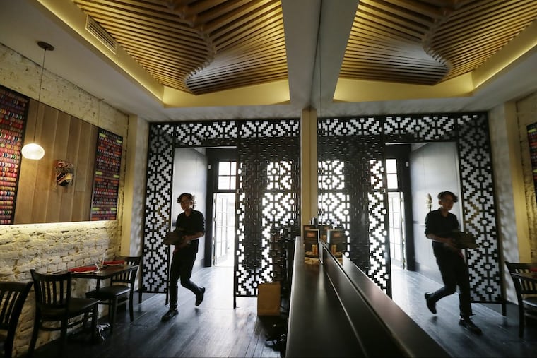 A staff member walks into the bar area from the.entrance to Vista Peru in Old City.