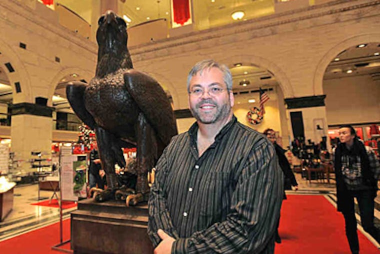 Author Michael J. Lisicky at the eagle in the old Wanamakers, now a Macy's. He has written a history of the store. (Sharon Gekoski-Kimmel/Staff)